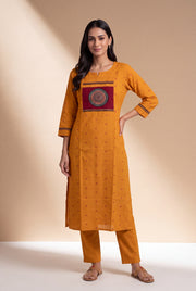 Mustard Cotton Kurti with Rust Butti and Chakrāvalī Patchwork